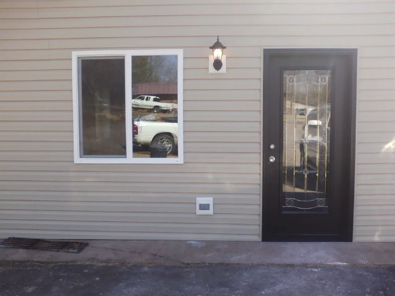New siding, window and entry door on the side of an addition in Silver Lake